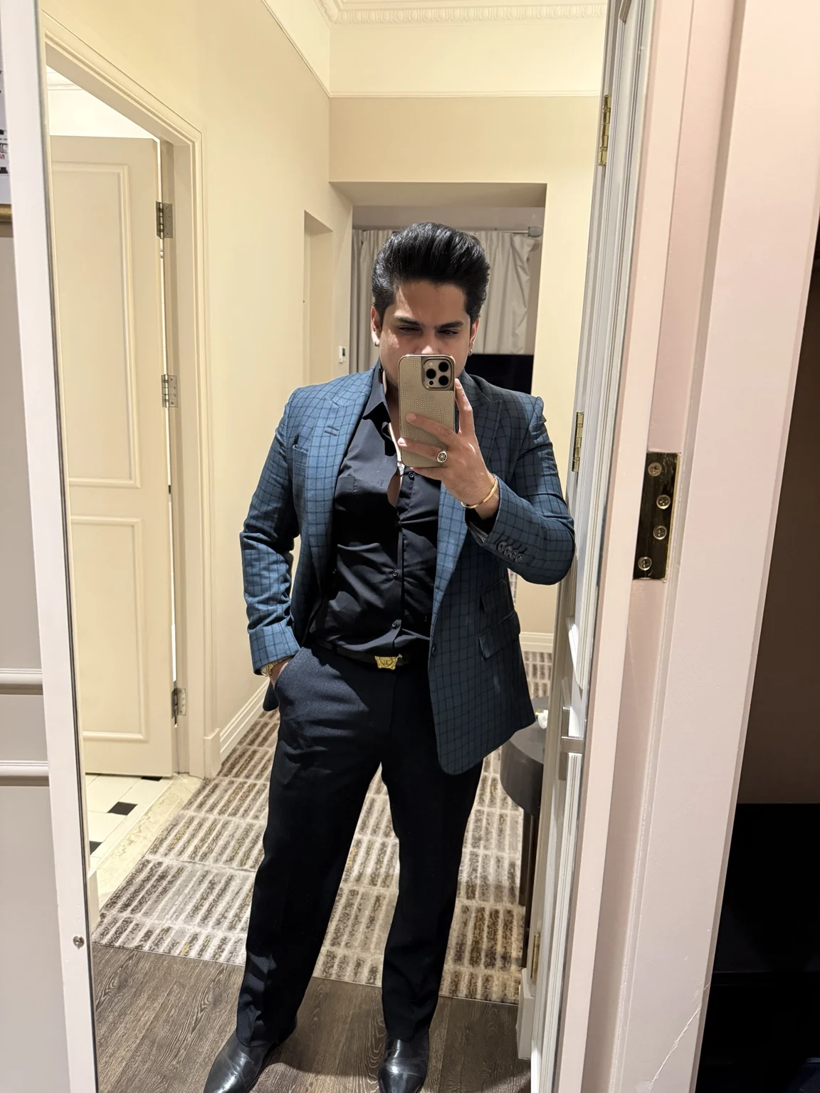 Muhammad Laraib Khan in formal attire holding a leather portfolio